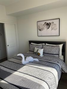 a bedroom with a bed with a swan on it at Rooftop getaway Niagara in Niagara Falls