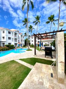 a villa with a pool and palm trees at Beach and pool life in Punta Cana