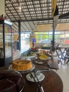 a counter with plates of food on a table at Pousada Toca do Ceará in Regencia Augusta