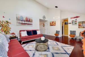 a living room with a red couch and a rug at Zen Den - Pocono LakeFront with Hot Tub ! in Pocono Summit