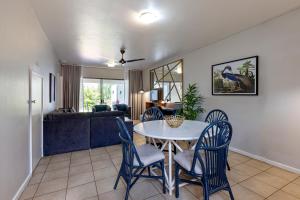 a dining room and living room with a table and chairs at Ocean Villa in Durban