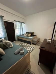 a bedroom with a bed and a table and a couch at 176 Calle Perez (Apt 1A) in San Juan