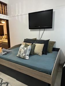 a bedroom with a bed with a flat screen tv on the wall at 176 Calle Perez (Apt 1A) in San Juan
