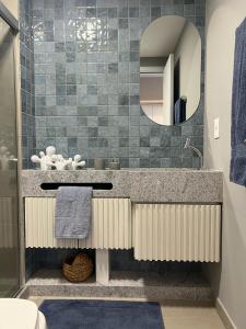 ein Badezimmer mit Waschbecken und Spiegel in der Unterkunft Flat Super Luxo - Boa Viagem in Recife