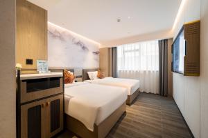 Voodi või voodid majutusasutuse Paco Hotel Botanical Garden Metro Guangzhou-Free Shuttle Bus For Canton Fair toas