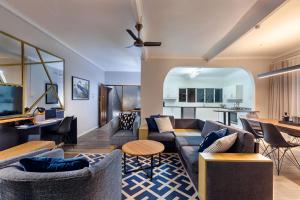 a living room with couches and a table at Ocean Villa in Durban