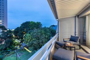 a balcony with a table and chairs on a building at Ocean Villa in Durban