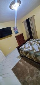 a bedroom with a bed and a ceiling at Finest Accommodation #528 Stem Ave Jacaranda 1 bedroom in Spanish Town
