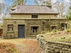 an old stone house with a blue door at 1 Bed in Glossop 52415 in Glossop