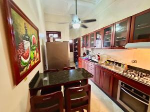 a kitchen with a counter top and a refrigerator at Grand Bazaar El Conde in Santo Domingo