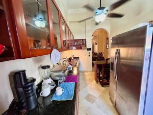 a kitchen with a refrigerator and a counter top at Grand Bazaar El Conde in Santo Domingo