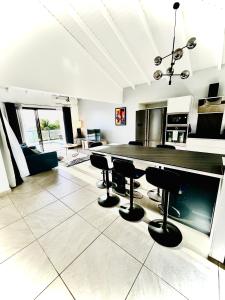 a large kitchen with a table and chairs at La villa O'rizon in Le Diamant