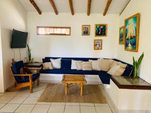 a living room with a blue couch and a table at Terraza Salvatore, Casa en Las Pocitas de Máncora in Máncora