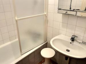 a bathroom with a shower and a toilet and a sink at Maison Charmante Près Plage et Forêt, 5 Ch., Jardin, Parking, Quartier Calme - FR-1-652-2 in Saint-Jean-de-Monts