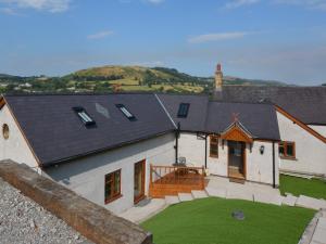 an aerial view of a house with a green yard at 2 Bed in Corwen 77351 in Corwen