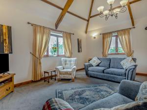 a living room with a couch and a chair at 3 bed property in Bude SHEPH in Merryfield