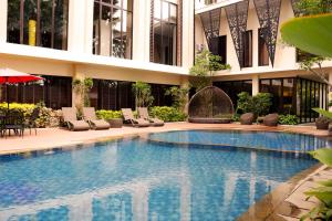 a swimming pool in front of a building at Emersia Hotel & Resort Batusangkar in Batusangkar