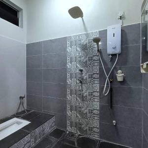 a bathroom with a shower and a sink at Ebnur Homestay in Arau +20 photos
