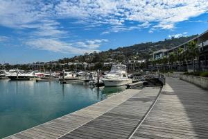 a dock with boats docked in a marina at Luxurious, Entertainers Delight! in Safety Beach