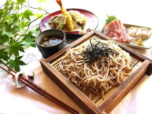 una bandeja de fideos y otra comida en una mesa en Guest houseTakagi - Vacation STAY 60566v, en Matsumoto