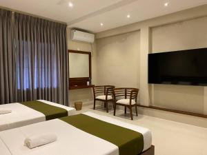 Postel nebo postele na pokoji v ubytování Lamandu City Hotel
