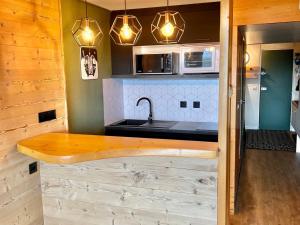 a kitchen with a sink and a counter top at Studio ski aux pieds avec balcon et fibre, 5 pers - FR-1-346-555 in Arc 1800