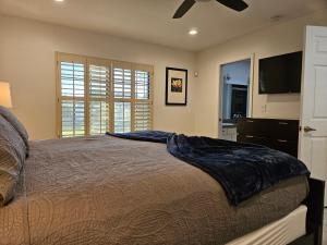 a bedroom with a bed and a ceiling fan at A Few Steps To Heated Pool, Tennis, Bike Trail in Scottsdale