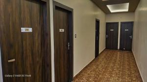 a hallway with three elevators in a building at OYO The Mount View in Jamshedpur