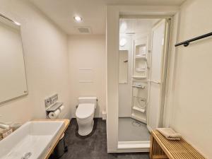 a bathroom with a toilet and a sink at HERE.Tokyo in Tokyo