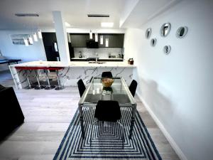 a dining room with a glass table and chairs at Amazing Large 2 Bedroom West Hollywood Apartment in Los Angeles