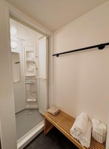 a small bathroom with a shower and a bench at HERE.Tokyo in Tokyo