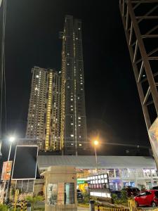 a tall building at night with cars in a parking lot at MG’s PLACE at Horizons 101 in Cebu City