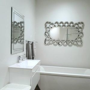 a white bathroom with a sink and a mirror at 700m From Franschhoek Center in Franschhoek