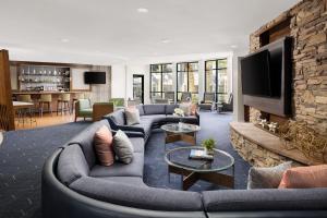 a living room with a couch and a fireplace at Courtyard By Marriott Las Vegas Stadium Area in Las Vegas