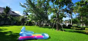 a plastic toy bunny sitting on the grass at Big swimming pool garden villa 私家泳池花园豪华别墅 in Na Jomtien