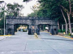 a stone archway in the middle of a street at Baguio Exotic Vacation House in Baguio