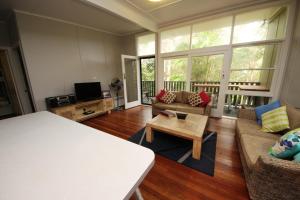 a living room with a couch and a coffee table at Little Bay Cottage - 8 East Street Arakoon in Arakoon