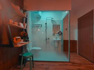 a bathroom with a glass shower and a sink at Banana homestay( Chuối Homestay) in Hue