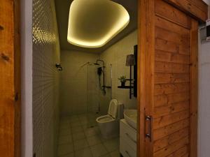 a bathroom with a toilet and a light on the ceiling at Lala Villa Koh Larn in Ko Larn