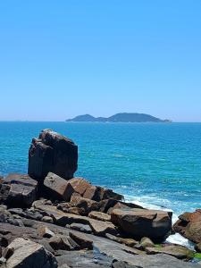 un grupo de rocas en la orilla del océano en Studio Morro das Pedras, en Florianópolis