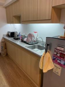 a kitchen with a sink and a counter top at Cubao Infina Towers 2121 NT in Manila