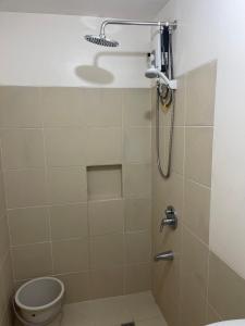a bathroom with a shower and a toilet at Cubao Infina Towers 2121 NT in Manila