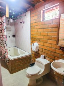 a bathroom with a toilet and a bath tub at flowers in Medellín