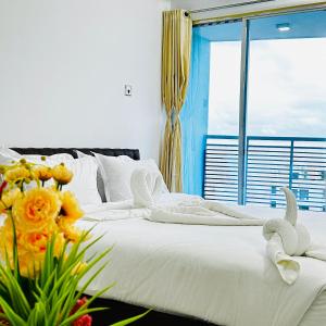 a bedroom with two beds with flowers and a window at Modern Resort in Cox's Bazar