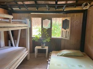 a room with two bunk beds and a table at Punta Arena EcoHostal & EcoFit 01 in Playa Punta Arena