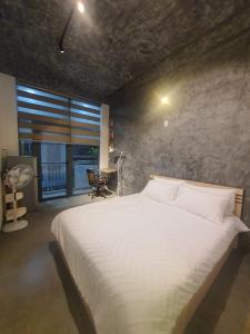 a bedroom with a large white bed in a room at ZVillage NCC - Modern Townhouse in District 1 in Ho Chi Minh City