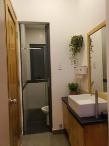 a bathroom with a toilet and a sink and a mirror at ZVillage NCC - Modern Townhouse in District 1 in Ho Chi Minh City
