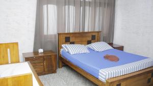 a bedroom with a bed with a blue and white comforter at Hillstreet Villa in Dehiwala