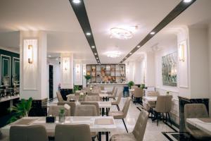 a restaurant with tables and chairs in a room at Riverside 1 Hotel in Can Tho
