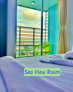 a bedroom with a bed with a view of a balcony at Modern Resort in Cox's Bazar